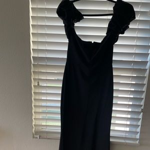 Black gown. Floor length with a slit on the left leg.Only worn once for picture